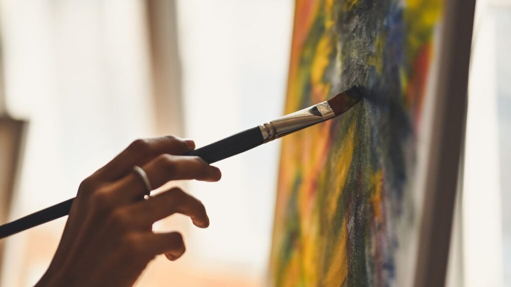 woman paiting on canvas showing how to make Bible verse wall art