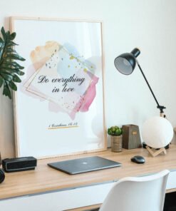 Do Everything in Love Wall Art in a black frame on the desk
