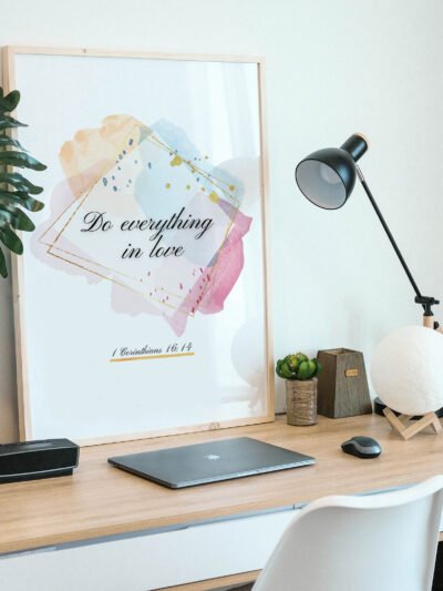 Do Everything in Love Wall Art in a black frame on the desk