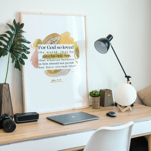 John 3:16 Wall Art on a wooden desk next to a laptop and a small palm tree