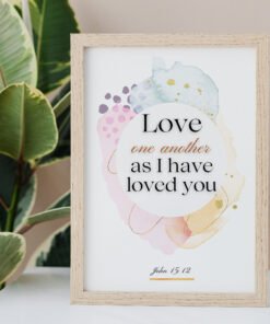 Love One Another Wall Art on the white table, palm next to it