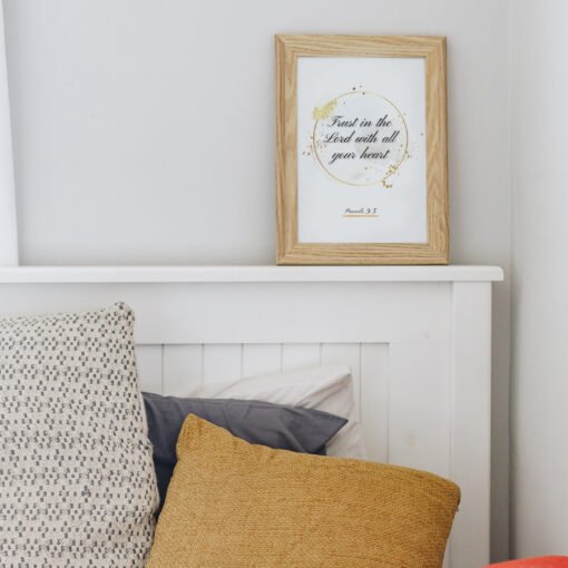 Trust in the Lord Wall Art hung above a bed in a white bedroom