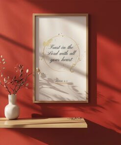 Trust in the Lord Wall Art on the red wall, ceramic vase with plants next to it
