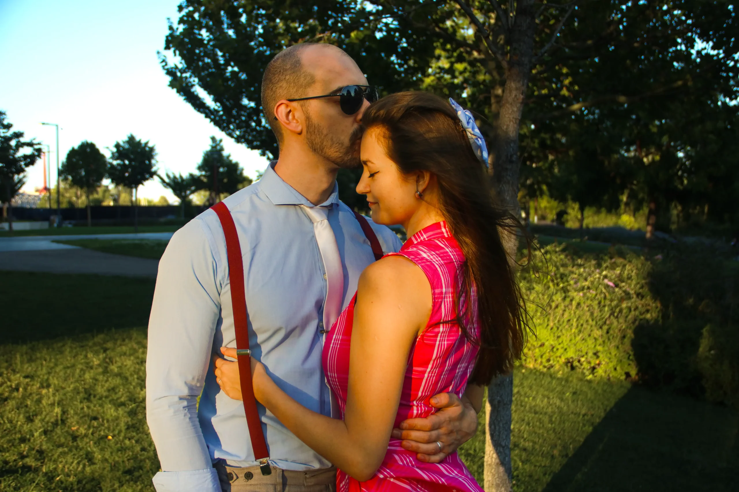 man kissing woman forehead