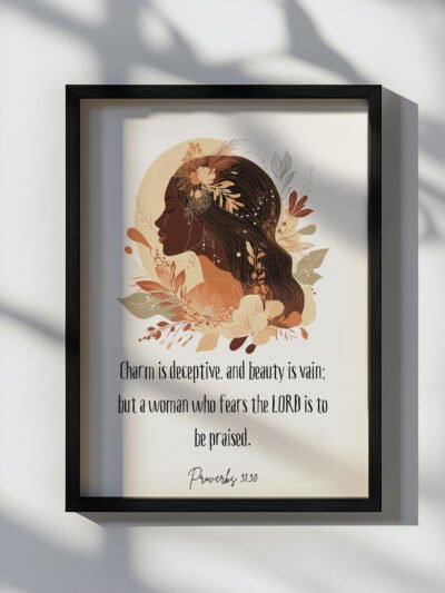 proverbs 31:30 wall art in a black frame hung on the white wall