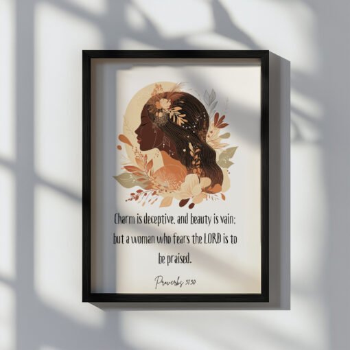 proverbs 31:30 wall art in a black frame hung on the white wall