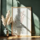 psalm 118 wall art leaning on a dark green wall, beige plants next to it