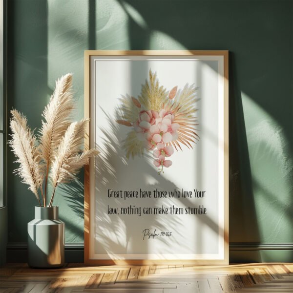 psalm 119 wall art in a white frame leaning on a dark green wall, vase with plants next to it