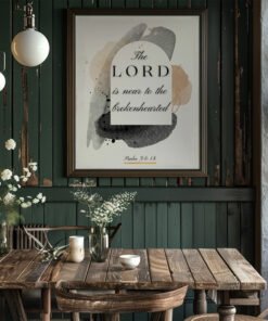 Psalm 34 wall art in a black frame hung in a dark green kitchen above the wooden table