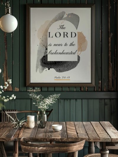 Psalm 34 wall art in a black frame hung in a dark green kitchen above the wooden table